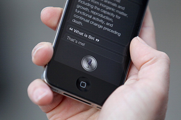 A man uses 'Siri' on the new iPhone 4S A man uses 'Siri' on the new iPhone 4S