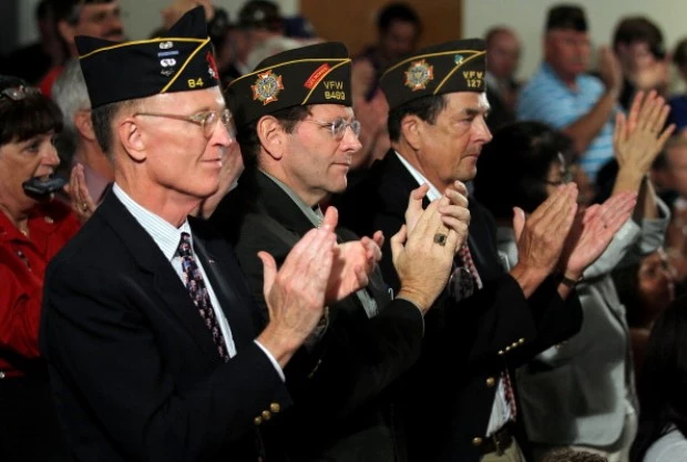 U.S. veterans, (L-R) Jim Hopper of the Army, Steve Hunt of the Navy, and Ronald Kirby of the Marine Corps, applaud U.S. veterans, (L-R) Jim Hopper of the Army, Steve Hunt of the Navy, and Ronald Kirby of the Marine Corps, applaud