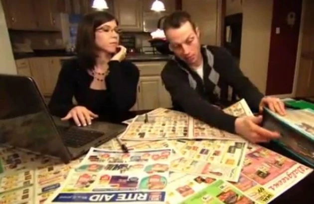 Extreme couponing couple planning their shopping trip Extreme couponing couple planning their shopping trip