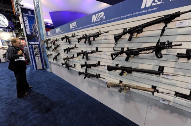 An attendee looks at Smith & Wesson M&P15's An attendee looks at Smith & Wesson M&P15's